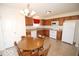 Inviting eat-in kitchen featuring wooden cabinets, white appliances, and a charming dining set perfect for Gathering meals at 11026 Cool Winds Way, Fishers, IN 46037