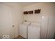 Well-equipped laundry room with a washer, dryer, and storage cabinet for convenient household chores at 11026 Cool Winds Way, Fishers, IN 46037