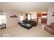 Open-concept living area with a cozy sofa, large windows, and access to the kitchen and dining area for easy living at 11026 Cool Winds Way, Fishers, IN 46037
