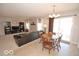 Open-concept living and dining area with a sectional sofa, TV, dining table, and sliding glass doors to the patio at 11026 Cool Winds Way, Fishers, IN 46037