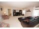 Bright living room with a comfortable seating area, TV, bookshelves, and large windows with natural lighting at 11026 Cool Winds Way, Fishers, IN 46037