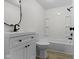 Modern bathroom featuring white cabinets, sleek black fixtures, and a neutral toned plank floor at 1159 S Bradley Ave, Indianapolis, IN 46203