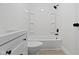 Well-lit bathroom with a combination tub/shower and white fixtures at 1159 S Bradley Ave, Indianapolis, IN 46203