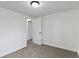A bright bedroom with neutral carpet, white walls, and a classic light fixture at 1159 S Bradley Ave, Indianapolis, IN 46203