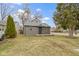 Cozy one-story home with gray siding, a small front porch and a well-maintained lawn and trees at 1159 S Bradley Ave, Indianapolis, IN 46203