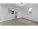Bright living room featuring neutral carpet and a view of the kitchen area through a partition at 1159 S Bradley Ave, Indianapolis, IN 46203