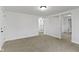 Spacious room with neutral carpet, white walls, and multiple doorways at 1159 S Bradley Ave, Indianapolis, IN 46203
