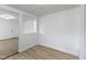 Bright and airy room with light wood-look flooring, white walls, and a partition view into the carpeted room at 1159 S Bradley Ave, Indianapolis, IN 46203