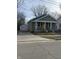 Quaint home with a yellow front door, cozy front porch, and a detached one car garage at 1237 E 29Th St, Anderson, IN 46016