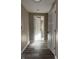 Hallway with modern vinyl flooring, white trim, and a view into a carpeted room at 1237 E 29Th St, Anderson, IN 46016