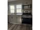 Updated kitchen with stainless steel appliances, shaker cabinets, and bright windows at 1237 E 29Th St, Anderson, IN 46016