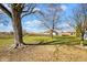 Large, level backyard featuring lawn and mature trees at 1310 Bowman Dr, Greenfield, IN 46140