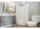 Bathroom with grey vanity, updated fixtures, a shower stall, and a toilet at 1310 Bowman Dr, Greenfield, IN 46140