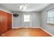 Comfortable bedroom with wood floors, a ceiling fan, and a large window at 1310 Bowman Dr, Greenfield, IN 46140