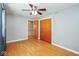 Bedroom with hardwood floors, closet with wooden door, grey walls and a ceiling fan with lighting at 1310 Bowman Dr, Greenfield, IN 46140