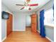 Bedroom with wood floors, closet, a window with curtains and a ceiling fan at 1310 Bowman Dr, Greenfield, IN 46140