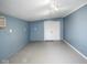Empty bonus room with blue brick walls, painted floor, white trim, and closet at 1310 Bowman Dr, Greenfield, IN 46140