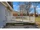 Cozy backyard deck with white railing, gravel, and view of a brick house in the background at 1310 Bowman Dr, Greenfield, IN 46140