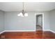 Dining room with hardwood floors and a view to a hallway with closet doors at 1310 Bowman Dr, Greenfield, IN 46140