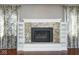 Living room fireplace with granite surround, custom mantle, and built-in shelving at 1310 Bowman Dr, Greenfield, IN 46140