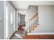Inviting foyer featuring a hardwood floor, staircase, and a glimpse into the adjacent room at 1310 Bowman Dr, Greenfield, IN 46140