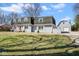 Charming home with detached garage, red front door, grey brick, shutters, and a well-maintained lawn at 1310 Bowman Dr, Greenfield, IN 46140