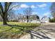 Charming home with detached garage, red front door, grey brick, shutters, and a well-maintained lawn at 1310 Bowman Dr, Greenfield, IN 46140