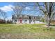 Charming home with a red front door, grey brick, shutters, and a well-maintained lawn at 1310 Bowman Dr, Greenfield, IN 46140