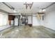 Unfinished garage with appliances, white door, and stairs leading up to storage above at 1310 Bowman Dr, Greenfield, IN 46140