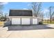 Exterior photo of a garage with two white doors and extra storage on the right side at 1310 Bowman Dr, Greenfield, IN 46140
