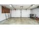 Spacious two car garage with white doors, ample storage space, and concrete floor at 1310 Bowman Dr, Greenfield, IN 46140