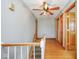 Upstairs hallway with hardwood floors, multiple doors, and a decorative ceiling fan at 1310 Bowman Dr, Greenfield, IN 46140
