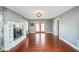 Open living room featuring hardwood floors, a fireplace, and French doors leading outside at 1310 Bowman Dr, Greenfield, IN 46140