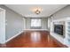 Spacious living room featuring hardwood floors and a fireplace with built-in shelving at 1310 Bowman Dr, Greenfield, IN 46140