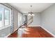 Bright living room with hardwood floors, large windows, and a view of the staircase at 1310 Bowman Dr, Greenfield, IN 46140