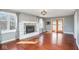 Sun-filled living room with fireplace, wood floors, large windows, and French doors at 1310 Bowman Dr, Greenfield, IN 46140