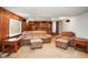 Cozy living room with wood paneling, carpeted floors, and plush furniture at 1310 Bowman Dr, Greenfield, IN 46140