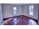 A sunny bedroom featuring hardwood floors and ample natural light from two windows at 1334 Hannibal St, Noblesville, IN 46060