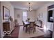 Dining area featuring hardwood floors, a stylish chandelier, and a window for natural light and a cozy ambiance at 1334 Hannibal St, Noblesville, IN 46060