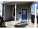 Inviting front porch with a blue door, offering a welcoming entrance and a cozy space to relax at 1334 Hannibal St, Noblesville, IN 46060