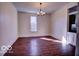 A spacious living room illuminated by an elegant chandelier and featuring gleaming hardwood floors at 1334 Hannibal St, Noblesville, IN 46060