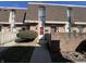 A charming townhome with a red brick facade, brown roofing, and well-maintained landscaping at 1344 Tishman Ln # 1344, Indianapolis, IN 46260