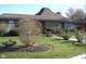 Charming brick home with well-maintained landscaping and a unique roof design at 1344 Tishman Ln # 1344, Indianapolis, IN 46260