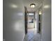 Hallway featuring neutral paint, tile flooring, and a view of the entry and bathroom at 1344 Tishman Ln # 1344, Indianapolis, IN 46260
