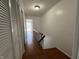 Hallway with wood floors and closet space leading to a bright room at 1344 Tishman Ln # 1344, Indianapolis, IN 46260