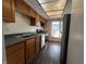 Classic kitchen with stainless steel appliances, wood cabinets, and a window to the backyard at 1344 Tishman Ln # 1344, Indianapolis, IN 46260
