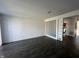 Spacious living room with white brick wall, hardwood floors, and an open layout at 1344 Tishman Ln # 1344, Indianapolis, IN 46260