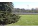 Community tennis court with mature trees and well-maintained grounds in the background at 1344 Tishman Ln # 1344, Indianapolis, IN 46260
