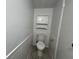 Small toilet room with white wainscoting, white toilet, and built in cabinet at 1344 Tishman Ln # 1344, Indianapolis, IN 46260