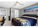 Comfortable bedroom featuring a ceiling fan, natural light, wooden desk, and modern decor at 13615 Moorcroft Dr, Fishers, IN 46037